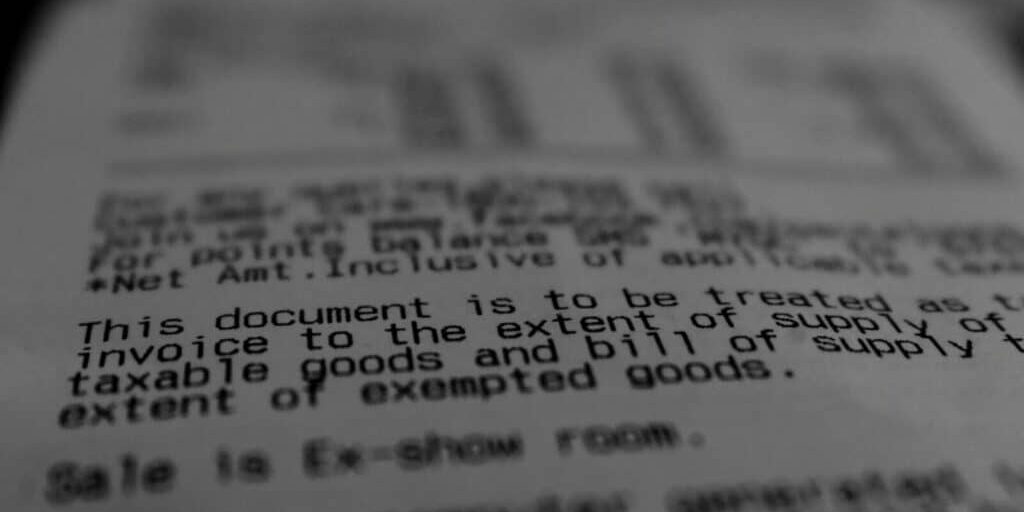 Close-up of a printed receipt highlighting, "This document is to be treated as an invoice to the extent of supply of taxable goods and bill of supply." Remember to review your client contract for accurate billing details.