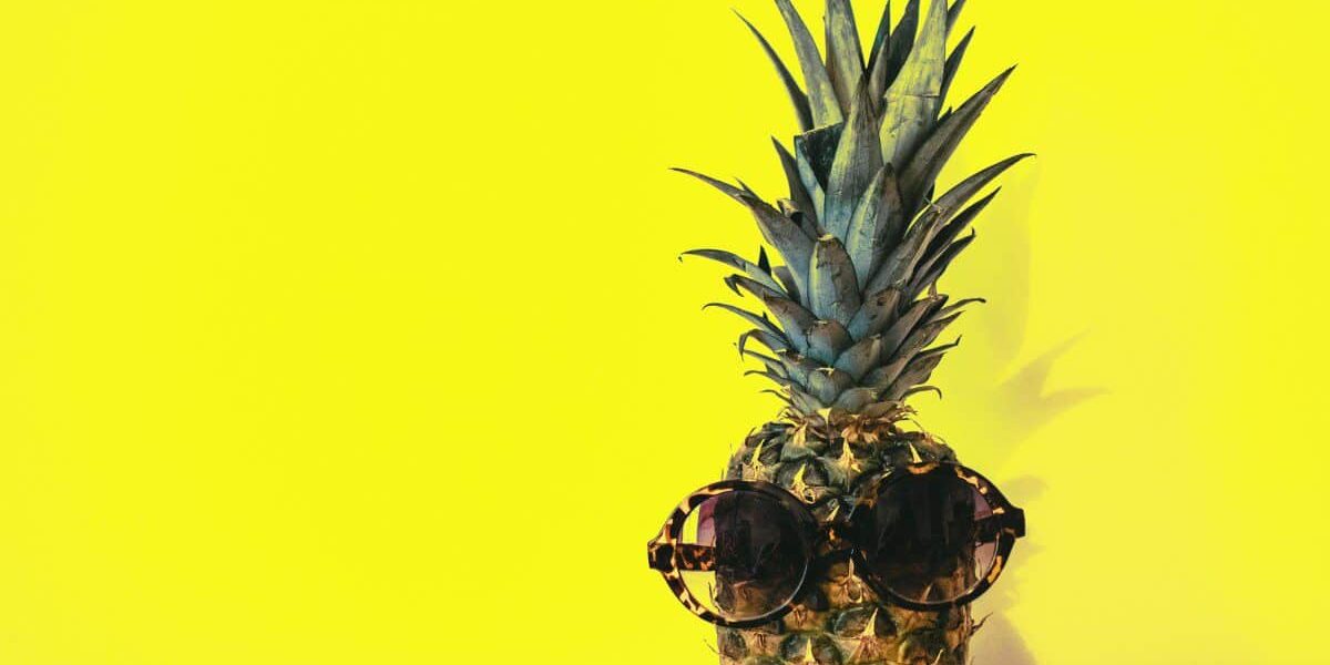 green-pineapple-fruit-with-brown-framed-sunglasses-beside-1161547